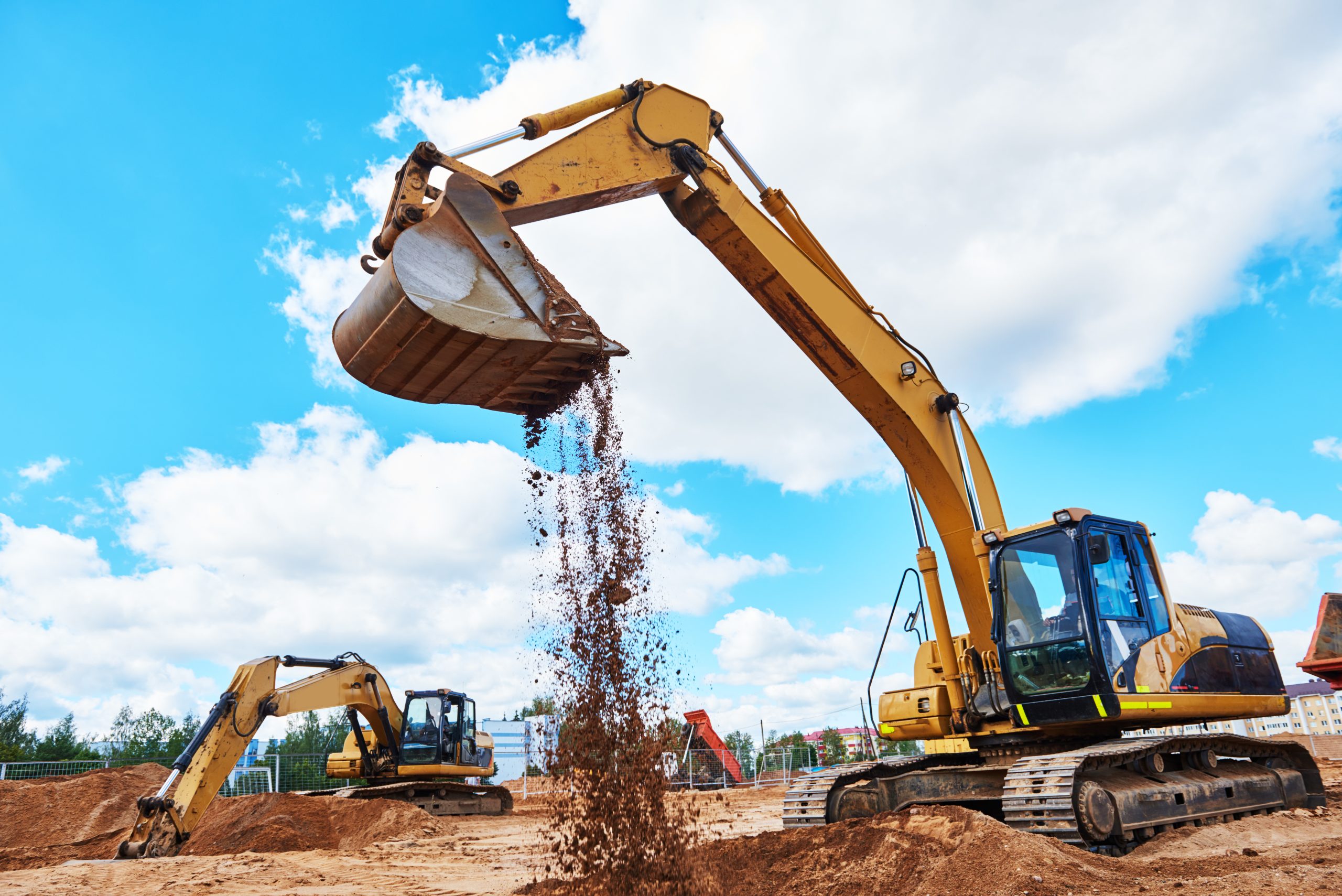 excavator machine loader doing earthmoving works at building construction site