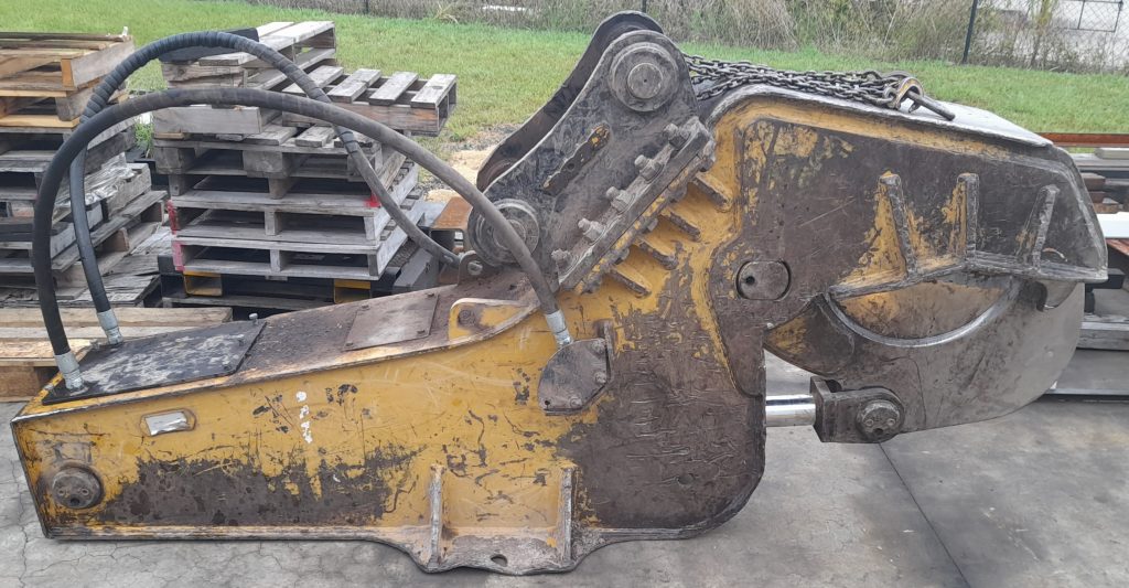 An orange tree shear attachment with a black hydraulic cylinder manufactured by A1 Hydraulic Engineering to suit hydraulic tree shear attachments such as Boss Attachments & Ironbark Equipment & OSA & Dymax & AR Equipment many other and also service and repair and reseal hydraulic cylinder for all excavators and other loaders or other earthmoving machines